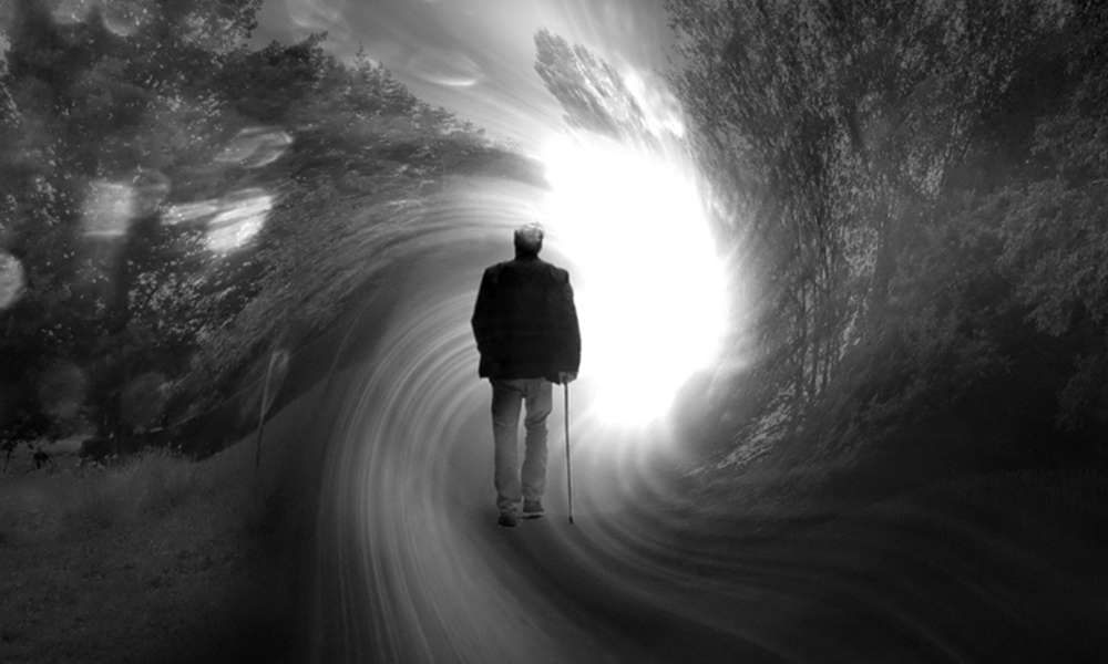 Old man walking into a swirl of light in the forest, symbolizing his peaceful death. In black and white