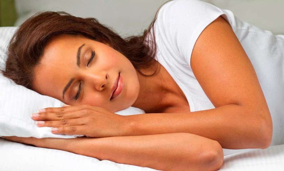 Woman sleeping well because she knows the best direction to sleep in.