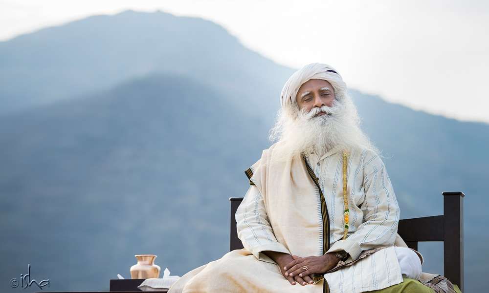 Sadhguru with eyes closed against the backdrop of Nilgiri Mountains | Stable like a Mountain
