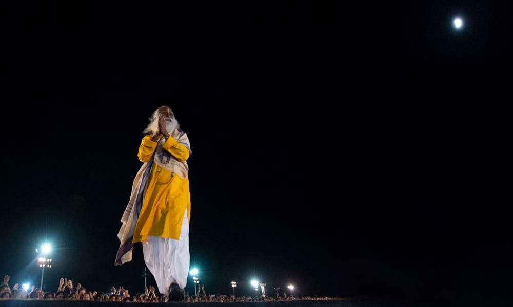 Sadhguru on the ramp on Guru Purnima, July 27, 2018; Lunar Eclipse visible in the upper background - Guru Purnima with Sadhguru - 2018