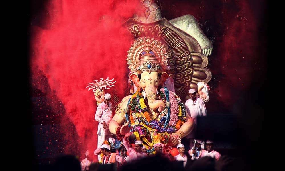 Big idol of Ganesh taken in a procession to be immersed into the ocean | The Symbolism of Ganesh Chaturthi