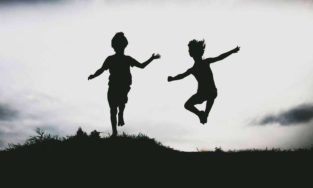 Two energetic kids playing in nature