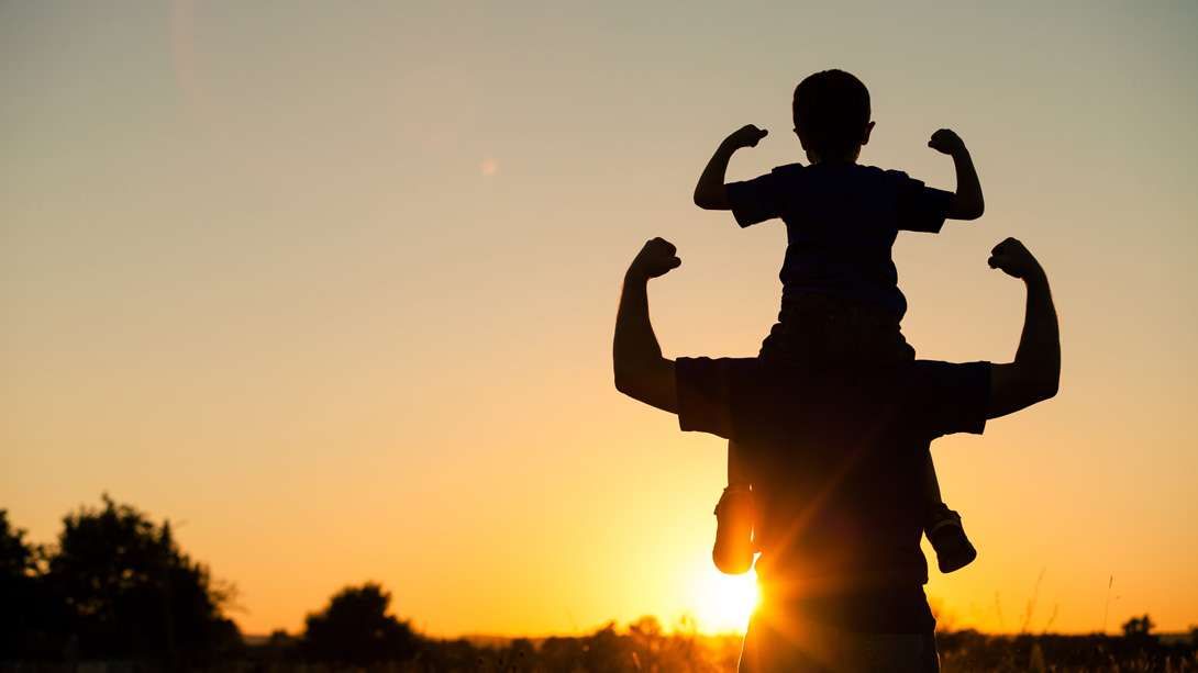 Fathers and sons: image of a son standing on the shoulders of his father