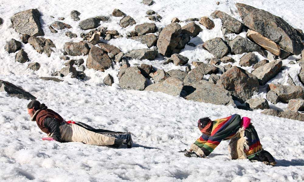 Pilgrims making the 52km circumambulation of Kailash with full-body prostration