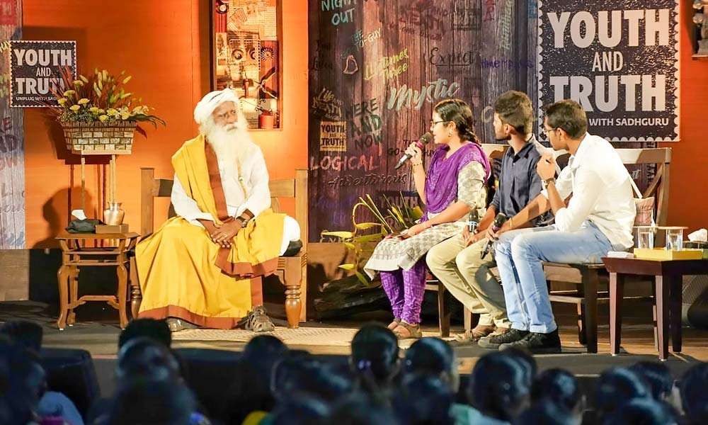 Sadhguru on stage with the three student moderators from Tamil Nadu Agricultural University | The Pulse of Youth AND Truth – TNAU