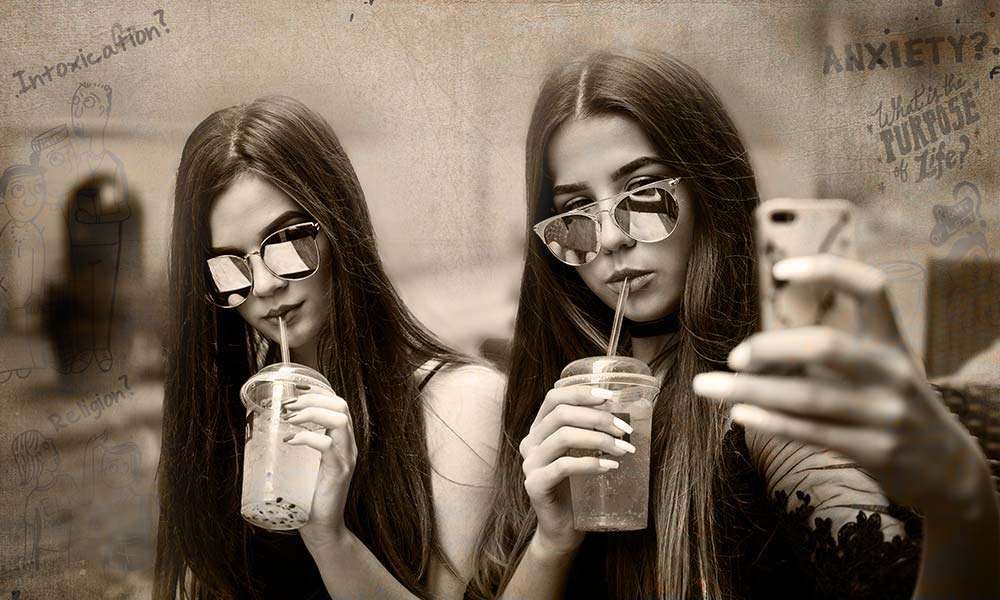 Two girls having a cold drink and taking selfie | Is it Wrong to Seek Attention Through Social Media?