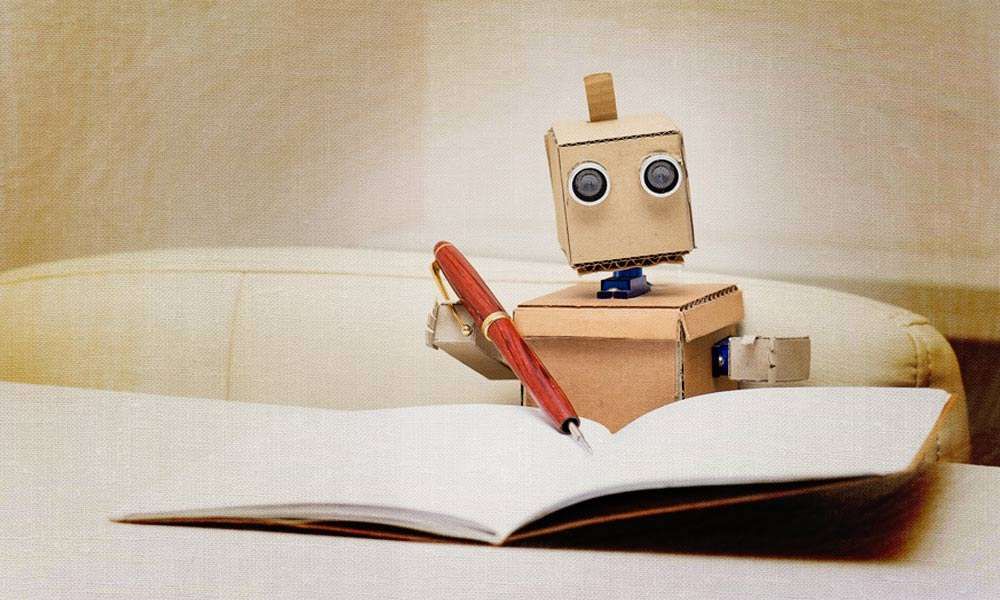 Cardboard Robot holding a fountain pen and notebook | Will Technology of the Future Become Boon or Bane?