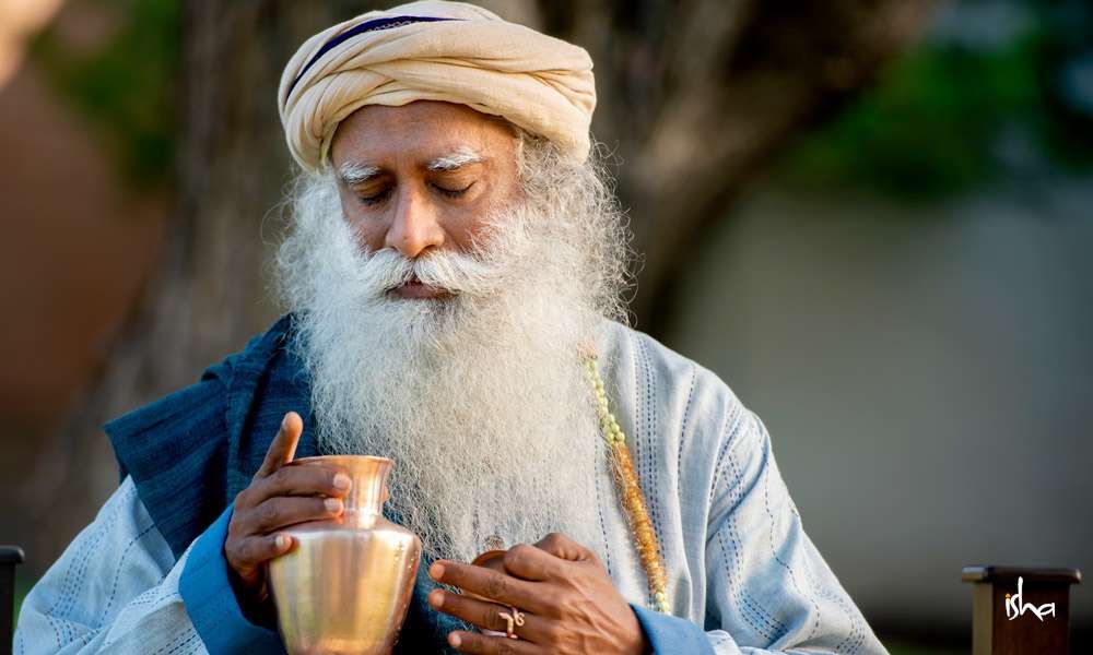 How to store and drink water at home: image of sadhguru holding a copper vessel full of water
