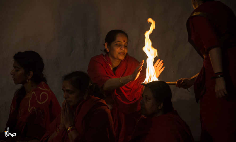 Devotee taking fire aarti prasad