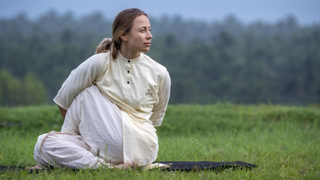 An Isha meditator performing matsyendrasana