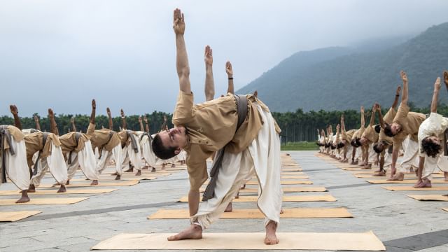 A group of meditators performing Trikonasana