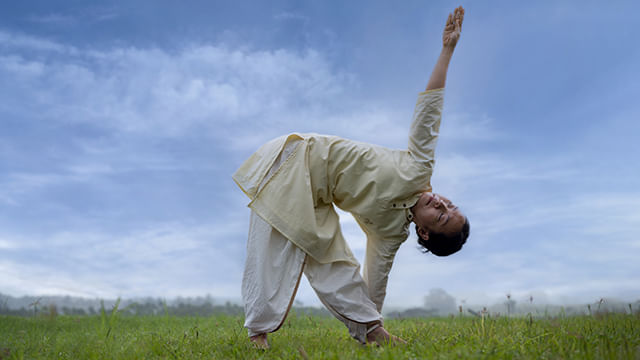 A meditator doing trikonasana