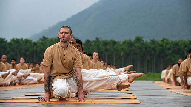 Meditators doing one of the Angamardana Aasanas