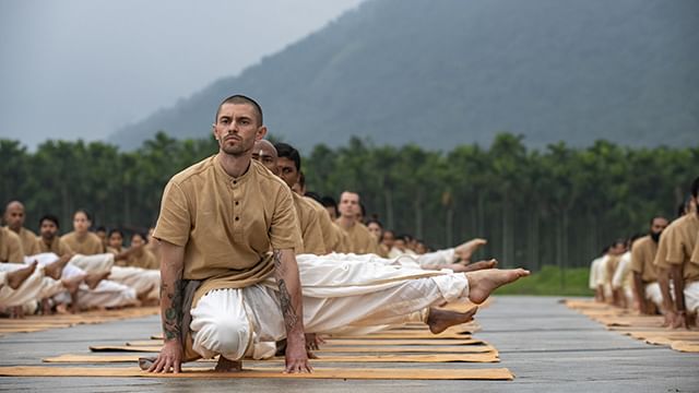 Meditators doing one of the Angamardana Aasanas