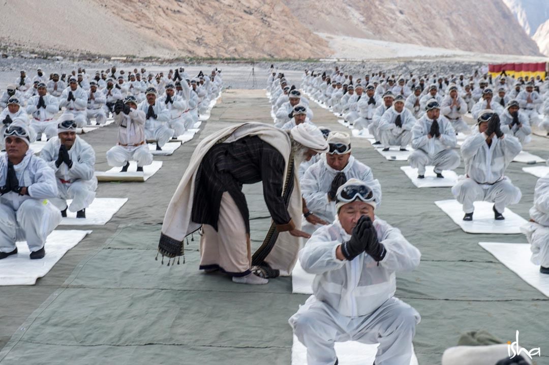 Sadhguru corrects a BSF soldier's posture during a Yoga session conducted for BSF soldiers at Siachen