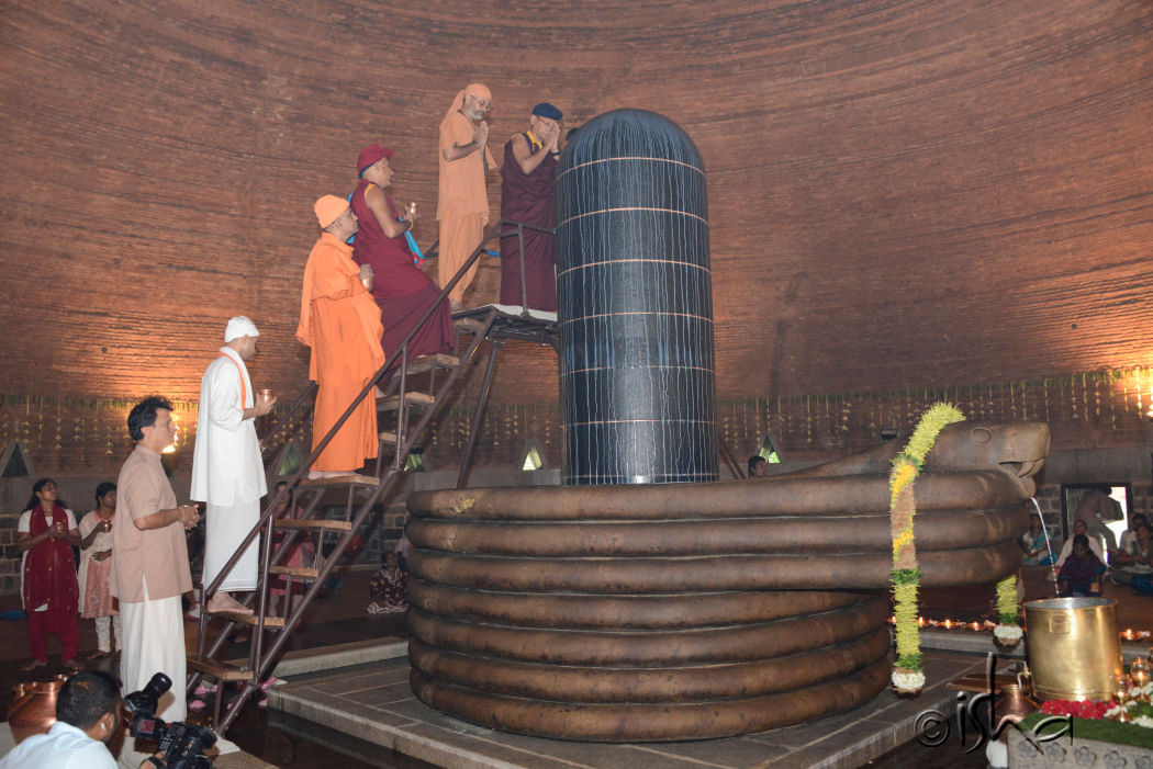 Monks offer milk to Dhyanalinga on the 14th Anniversary of Dhyanalinga Consecration, 2014